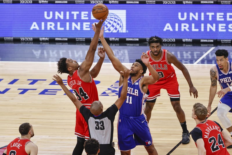 Chicago Bulls center Wendell Carter Jr. (34) and Philadelphia 76ers center Tony Bradley (11) battle for the ball at the tip-off at United Center.