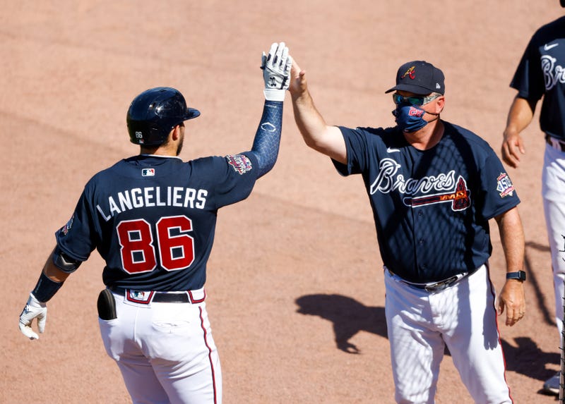Atlanta Braves catcher Shea Langeliers (86) is greeted by hitting coach Kevin Seitzer (28) (R) after hitting a home run against the Tampa Bay Rays in the eighth inning during spring training at CoolToday Park.