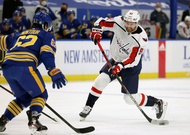 Brandon Montour defends against Evgeny Kuznetsov