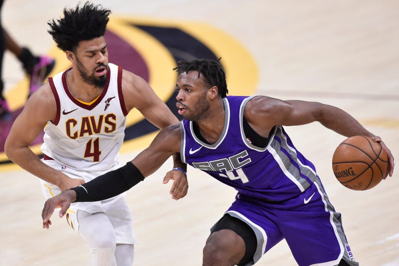 Mar 22, 2021; Cleveland, Ohio, USA; Sacramento Kings guard Buddy Hield (24) dribbles the ball against Cleveland Cavaliers guard Quinn Cook (4) in the fourth quarter at Rocket Mortgage FieldHouse.