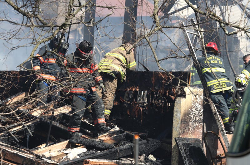 Firefighters work at the scene of a major fire at the Evergreen Court Home for Adults in Spring Valley March 23, 2021