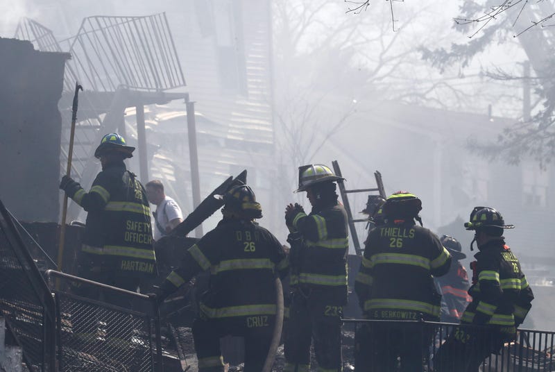 Firefighters work at the scene of a major fire at the Evergreen Court Home for Adults in Spring Valley March 23, 2021