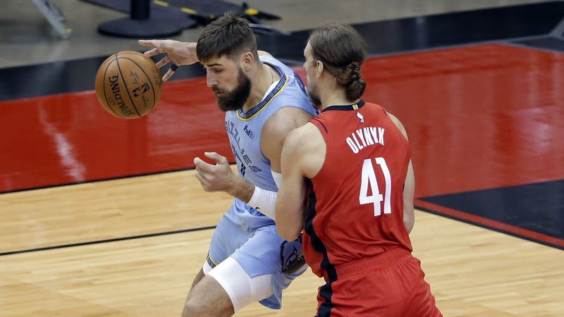 Memphis Grizzlies center Jonas Valanciunas (left) tries to drive around Houston Rockets forward Kelly Olynyk (41) during the first half at Toyota Center.