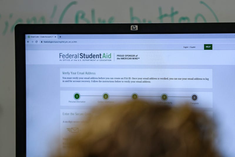 Students and families complete FAFSA forms online during an assistance event