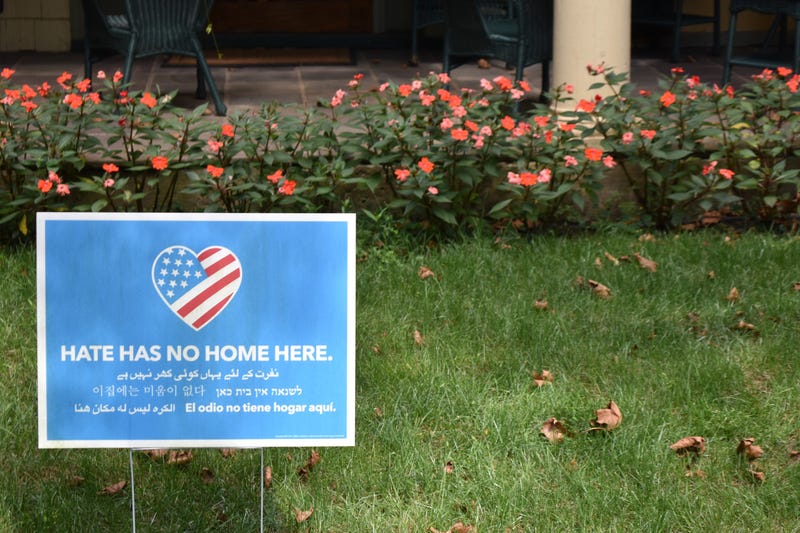 A lawn sign reads "Hate Has No Home Here"