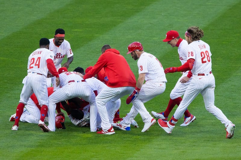 Philadelphia Phillies shortstop Jean Segura (2) is mobbed by teammates after hitting a walk off RBI single during the tenth inning against the Atlanta Braves at Citizens Bank Park.