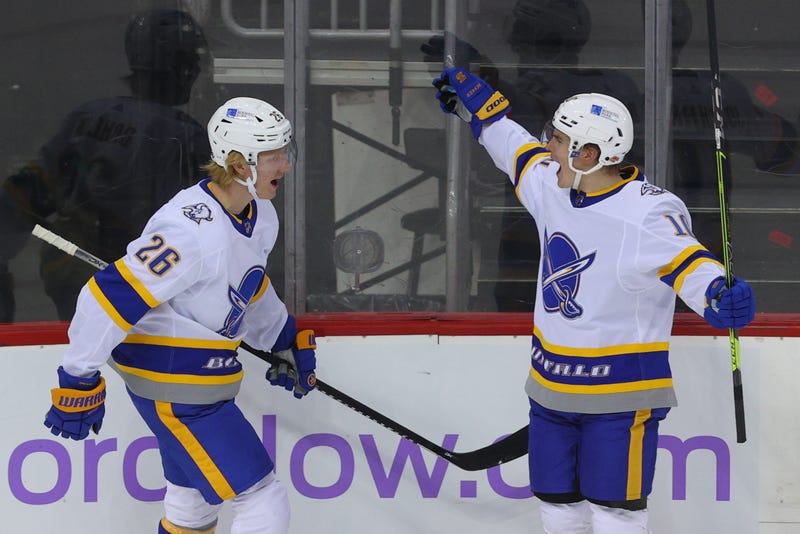 Rasmus Dahlin celebrates his goal with Henri Jokiharju