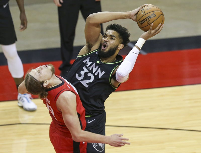 Minnesota Timberwolves center Karl-Anthony Towns (32) is blocked by Houston Rockets forward Kelly Olynyk (41) in the first quarter at Toyota Center.