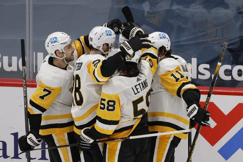 Pittsburgh Penguins left wing Zach Aston-Reese (12) celebrates with teammates after scoring a goal 