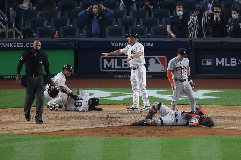 New York Yankees second baseman Rougned Odor (18) and Houston Astros catcher Martin Maldonado (15) react after colliding at home plate during the sixth inning at Yankee Stadium.