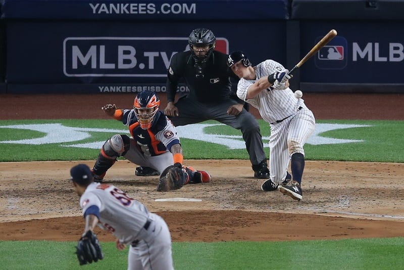 New York Yankees first baseman DJ LeMahieu (26) hits an RBI infield single against Houston Astros relief pitcher Bryan Abreu (66) during the sixth inning at Yankee Stadium.