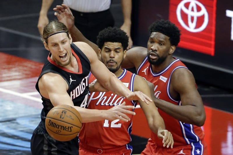 Houston Rockets forward Kelly Olynyk, left, loses the ball in front of Philadelphia 76ers forward Tobias Harris (12) and center Joel Embiid, right, during the first half at Toyota Center.