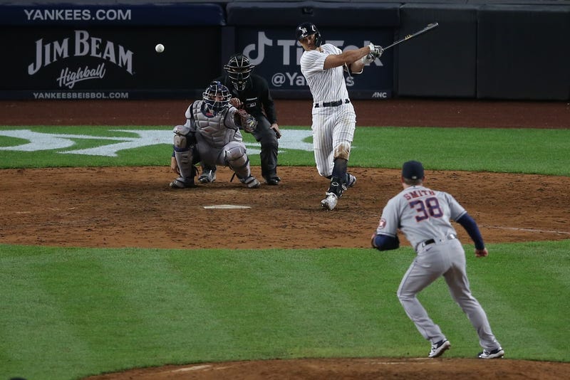 New York Yankees designated hitter Giancarlo Stanton (27) hits an RBI single against Houston Astros relief pitcher Joe Smith (38) during the eighth inning at Yankee Stadium.
