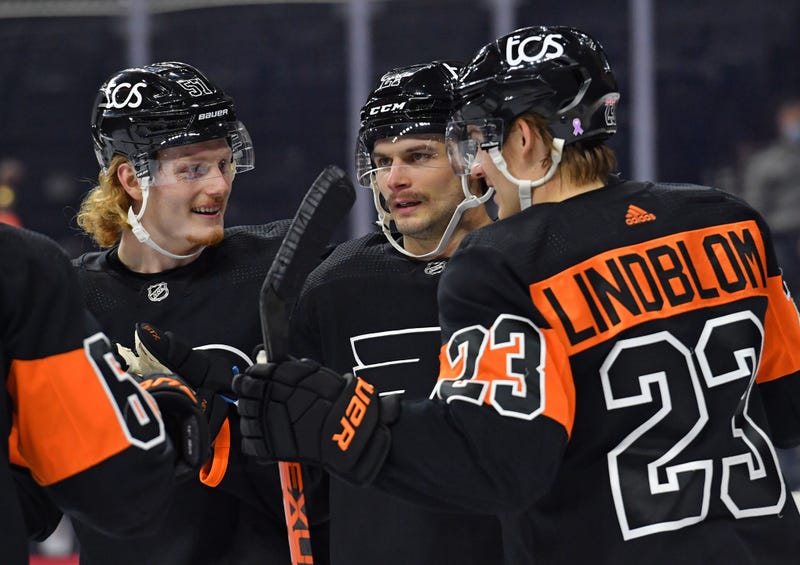 Philadelphia Flyers right wing Wade Allison (57), left wing Scott Laughton (21) and left wing Oskar Lindblom (23)