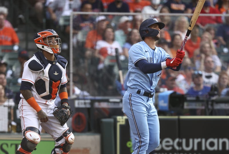 Toronto Blue Jays third baseman Cavan Biggio (8) hits a home run as Houston Astros catcher Martin Maldonado (15) looks on during the second inning at Minute Maid Park.