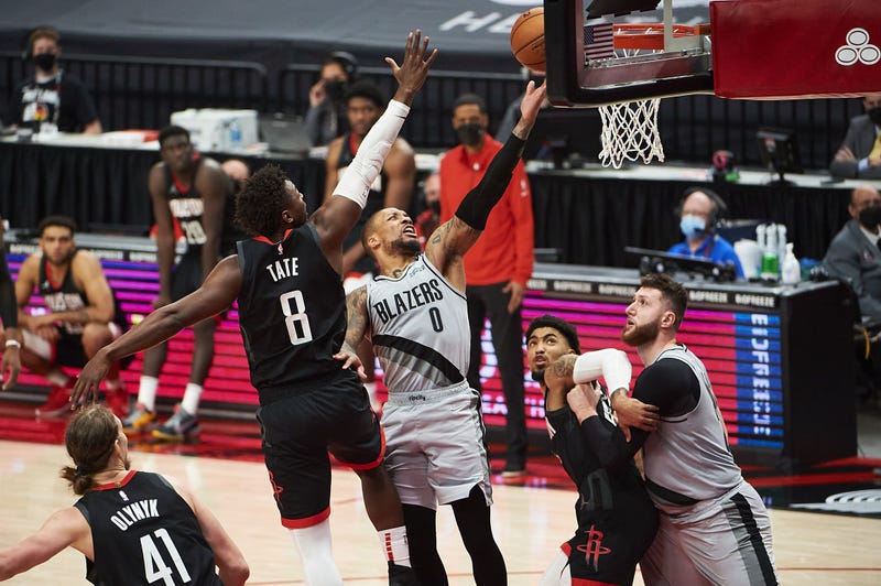 Portland Trail Blazers guard Damian Lillard (0) scores a basket during the second half against Houston Rockets forward Jae'Sean Tate (8) at Moda Center. The Trail Blazers won the game 140-129.