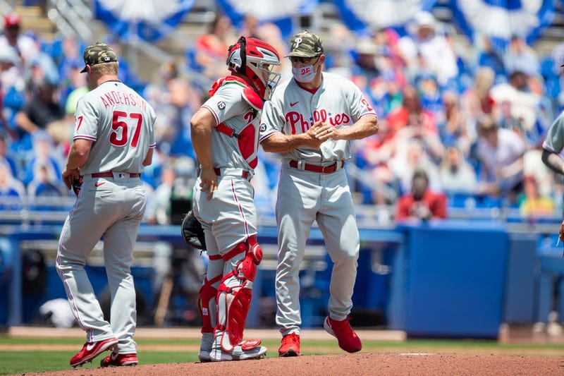 Philadelphia Phillies manager Joe Girardi (25) talks with catcher Rafael Marchan (12) during a pitching change in the second inning of a game against the Toronto Blue Jays at TD Ballpark.