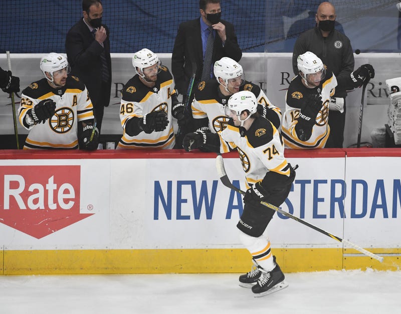 left wing Jake DeBrusk (74) is congratulated by teammates after scoring 