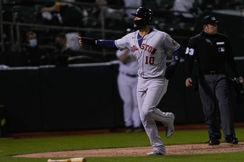 Houston Astros first baseman Yuli Gurriel (10) signals to his teammates after returning home during the seventh inning against the Oakland Athletics at RingCentral Coliseum.