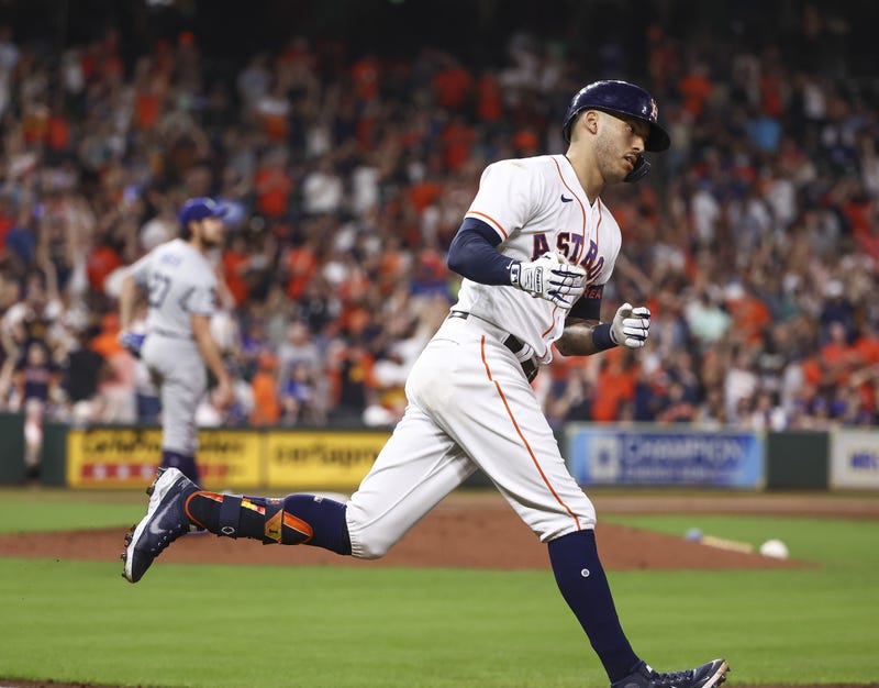 Los Angeles Dodgers starting pitcher Trevor Bauer (27) reacts as Houston Astros shortstop Carlos Correa (1) rounds the bases after hitting a home run during the sixth inning at Minute Maid Park.