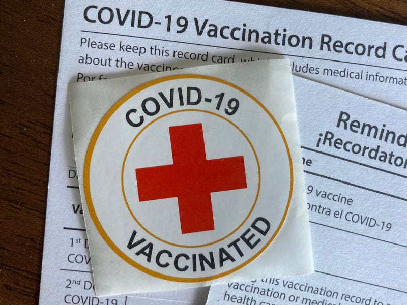 Vaccination cards and a sticker.