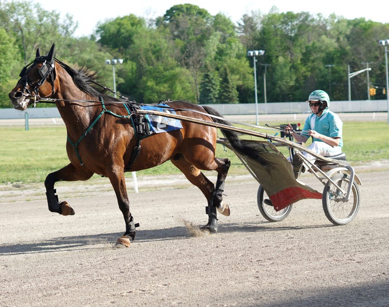 A jockey warms up his horse before the first race of the night at Northville Downs on May 21, 2021.
