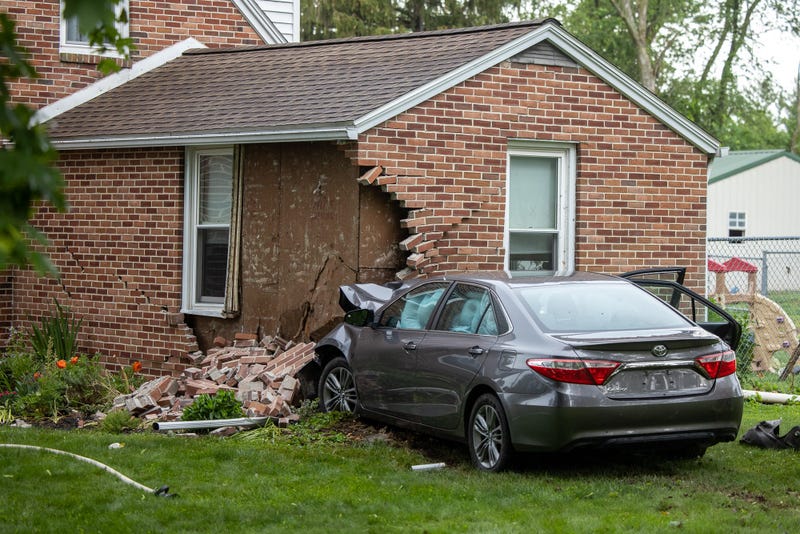 Debris is scattered after a car struck a house