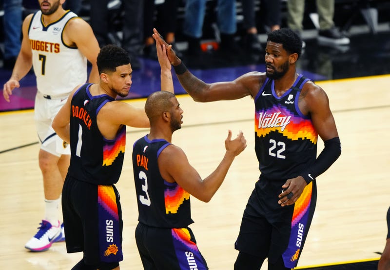 Suns stars Chris Paul, Devin Booker, and Deandre Ayton on the court.