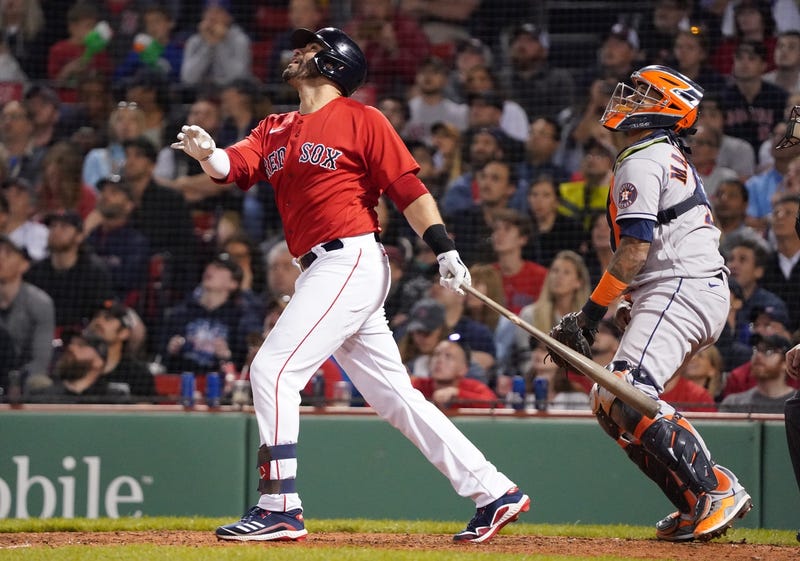 Boston Red Sox left fielder J.D. Martinez (28) hits a sacrifice fly to bring in a run against the Houston Astros in the eighth inning at Fenway Park.
