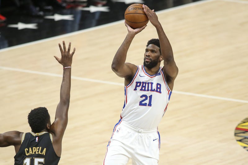Philadelphia 76ers center Joel Embiid (21) shoots over Atlanta Hawks center Clint Capela (15)