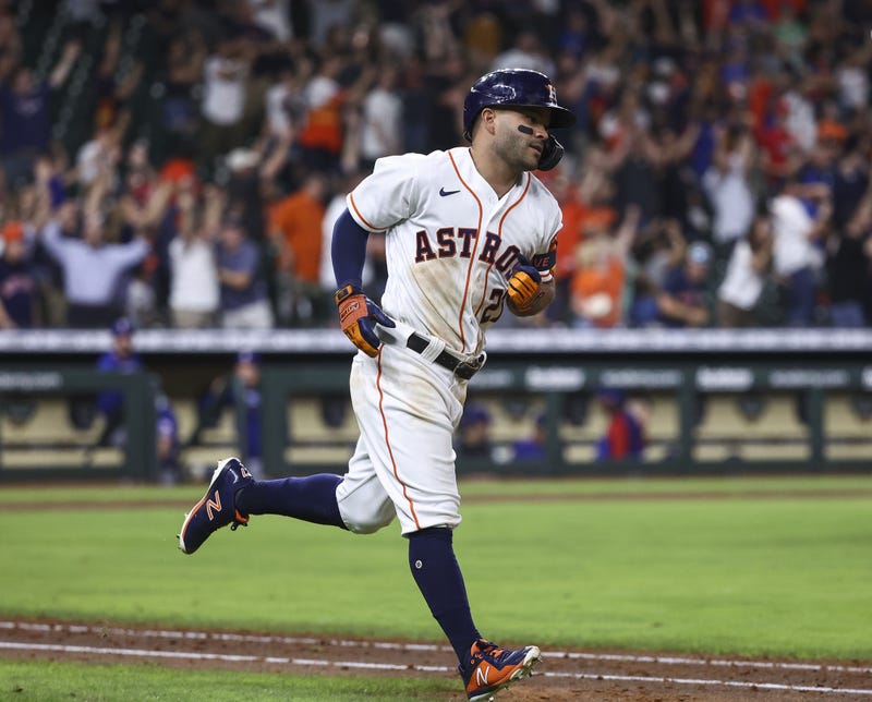Houston Astros second baseman Jose Altuve (27) hits a walk-off grand slam home run during the tenth inning against the Texas Rangers at Minute Maid Park.