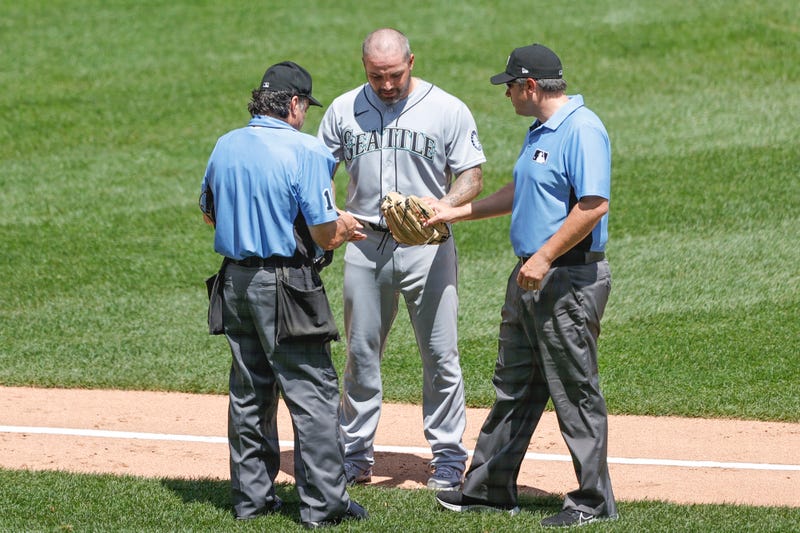 Umpires check Hector Santiago's glove for illegal foreign substances