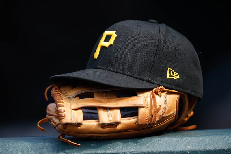 A general view of a Pittsburgh Pirates glove and hat in the eighth inning against the Colorado Rockies at Coors Field.
