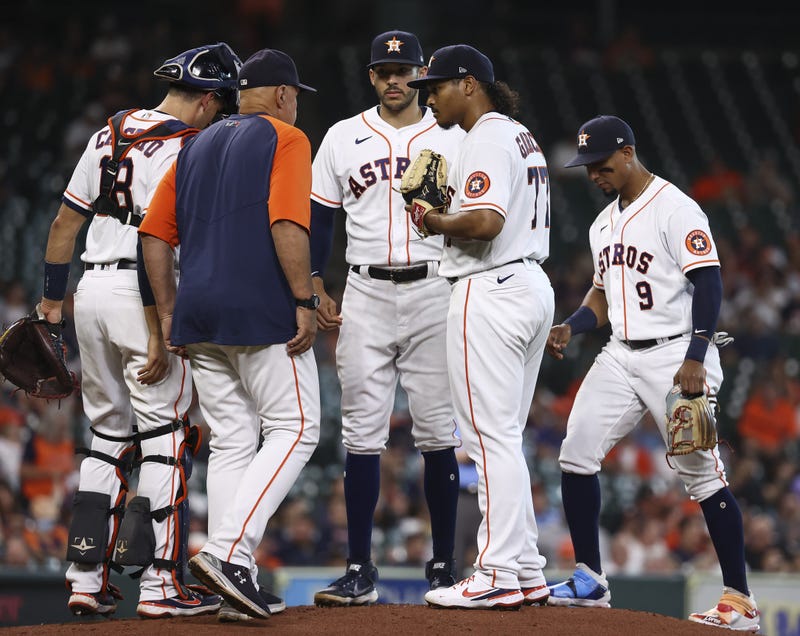 Houston Astros starting pitcher Luis Garcia (77) talks with pitching coach Brent Strom on the mound during the first inning against the Baltimore Orioles at Minute Maid Park.