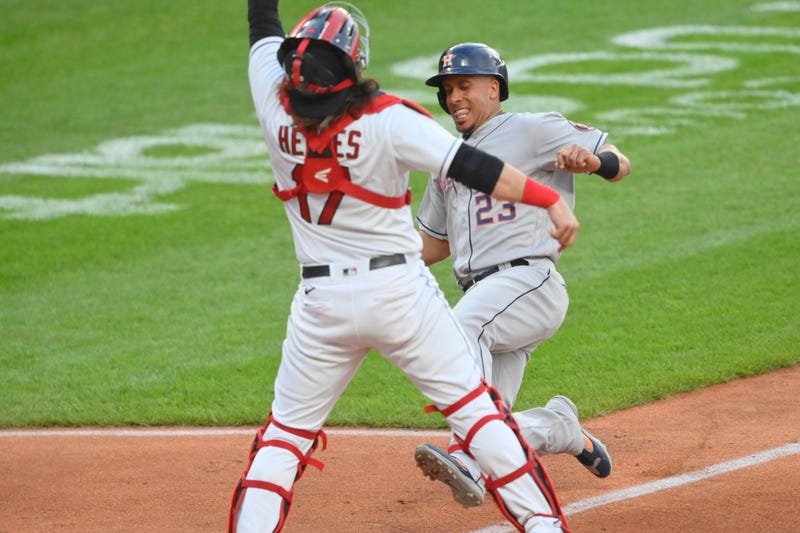 Jul 2, 2021; Cleveland, Ohio, USA; Houston Astros designated hitter Michael Brantley (23) scores against Cleveland Indians catcher Austin Hedges (17) in the third inning at Progressive Field.