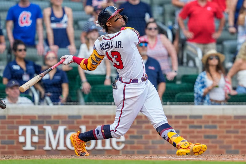 Jul 4, 2021; Cumberland, Georgia, USA; Atlanta Braves right fielder Ronald Acuna Jr. (13) drives in the game tying run with a sacrifice fly against the Miami Marlins during the ninth inning at Truist Park.