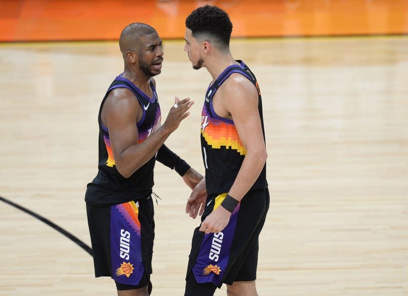 Suns stars Chris Paul and Devin Booker on the court.