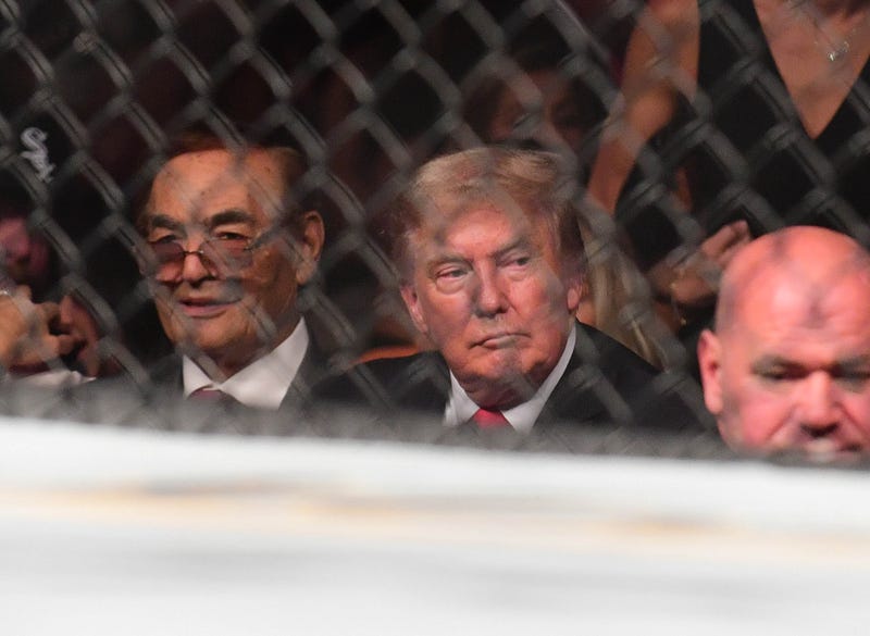 0Former US President Donald Trump attends UFC 264 at T-Mobile Arena in Las Vegas on July 10, 2021. To his lift is UFC's Dana White.