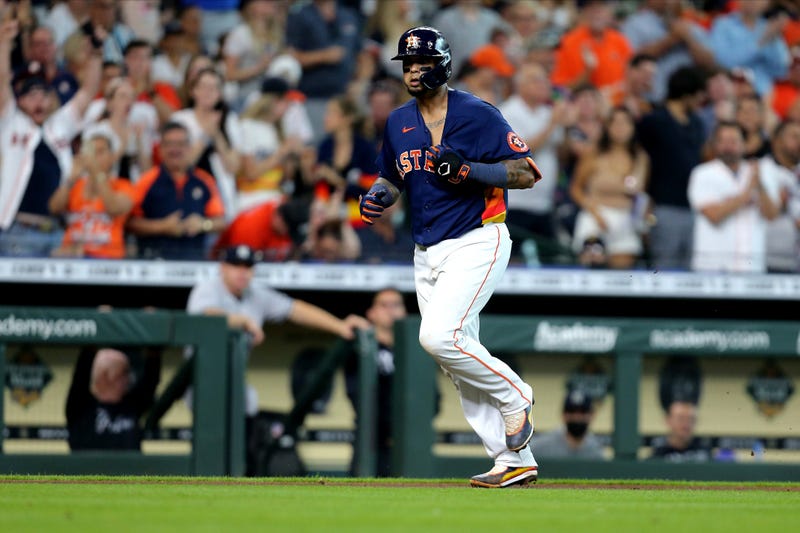 Houston Astros catcher Martin Maldonado (15) tugs on his jersey after hitting a home run against the New York Yankees during the third inning at Minute Maid Park.