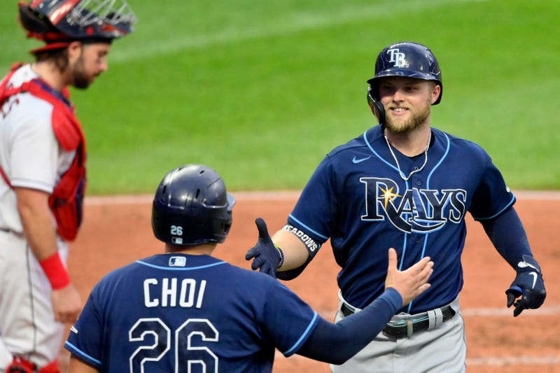 Jul 24, 2021; Cleveland, Ohio, USA; Tampa Bay Rays left fielder Austin Meadows (right) celebrates with first baseman Ji-Man Choi (26) after hitting a two-run home run against the Cleveland Indians in the third inning at Progressive Field. 