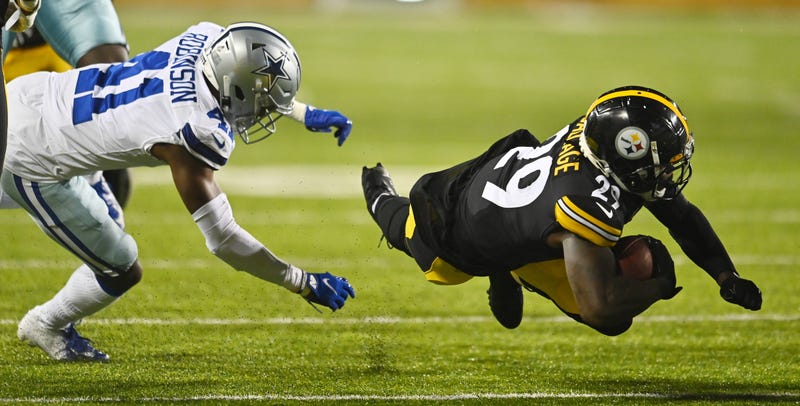running back Kalen Ballage (29) dives for yardage