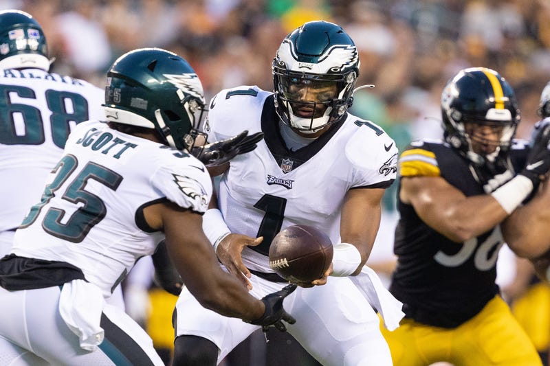 Philadelphia Eagles quarterback Jalen Hurts (1) hands off to running back Boston Scott (35)