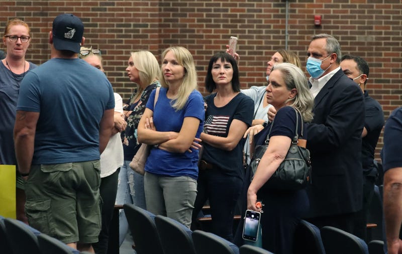 John Lanave, Clarkstown Schools Assistant Supervisor of Business, far right, asks unmasked attendees to leave during a Clarkstown School Board meeting at Clarkstown South in West Nyack Aug. 12, 2021