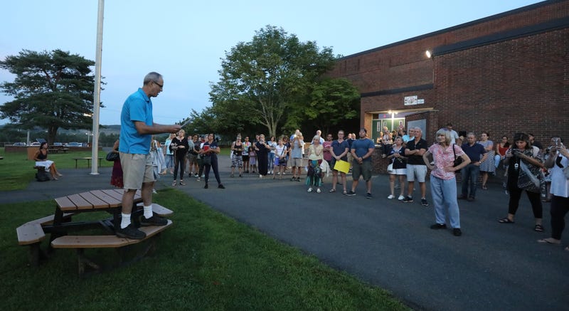People speak outside of Clarkstown South in West Nyack after a Clarkstown School Board meeting was adjourned early when many attendees refused to wear masks Aug. 12, 2021