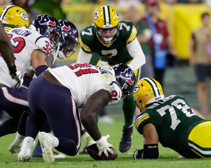 Houston Texans defensive tackle Jaleel Johnson (91) recovers a fumble against Green Bay Packers quarterback Kurt Benkert (7) and offensive tackle Cole Van Lanen (78) during their football game at Lambeau Field in Green Bay.