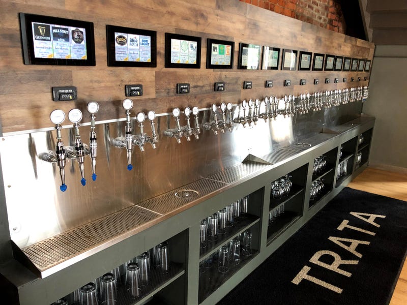 Self-serve taps for beer and cider are seen at a bar 