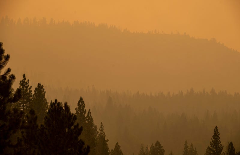 Smoke coming from the Caldor Fire overtakes a large mountain in El Dorado County, Calif., on Wednesday, Aug. 18, 2021.