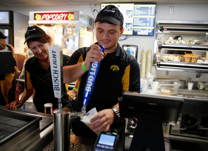 Tyler Doering of Mahtomedi, Minnesota, pours a glass of Bud Light prior to kickoff between Iowa and Indiana at Kinnick Stadium in Iowa City on Saturday, Sept. 4, 2021