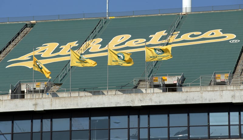Oakland Athletics championship flags fly over the grandstand at RingCentral Coliseum.