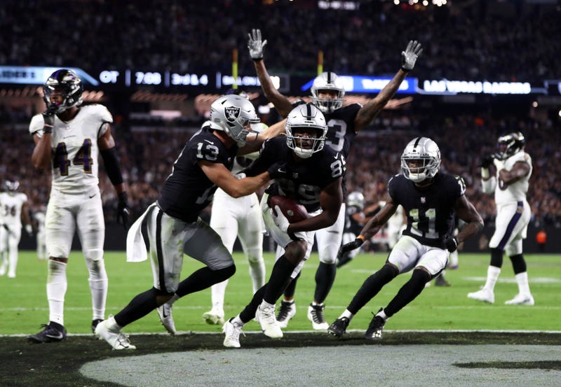 The Raiders celebrate their game-winning OT touchdown